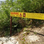 Crocodile warning sign on the beach in Port Douglas