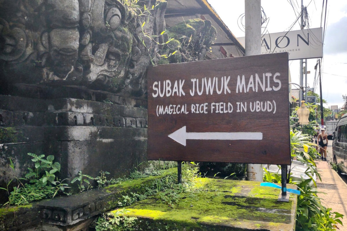 Sign post showing direction of magical secret rice field walk in Ubud.