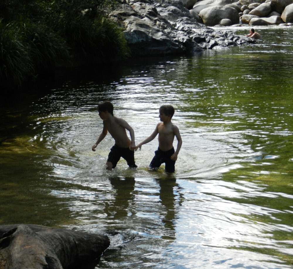 australia kids swim in water hole