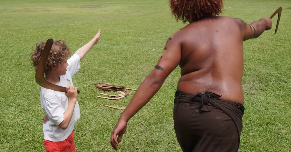 australia with kids child throwing boomerang