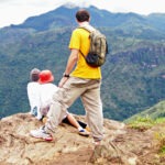 View from the top of Little Adam's Peak Sri Lanka. Father and two kids looking at the view.