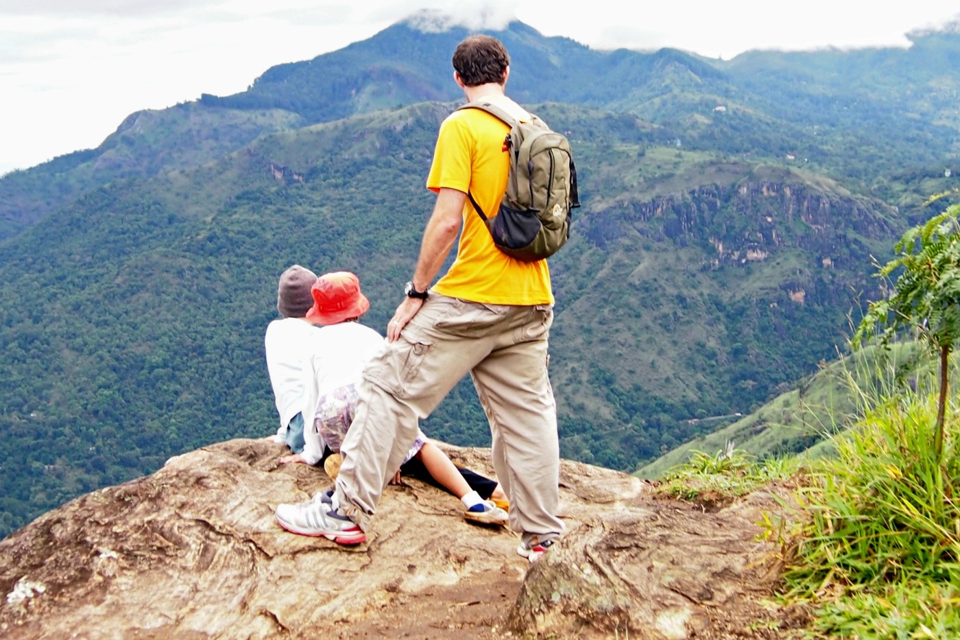 View from the top of Little Adam's Peak Sri Lanka. Father and two kids looking at the view.