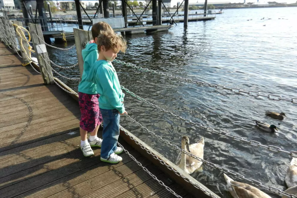 UK with kids feeding ducks