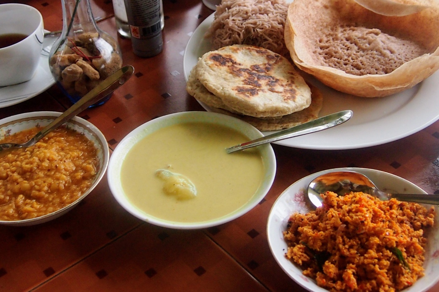 Sri Lankan foods, string hoppers, hoppers, roti, dal, coconut sambol and egg curry.