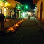 Street scene in Flores Guatemala at night flower carpets and candles