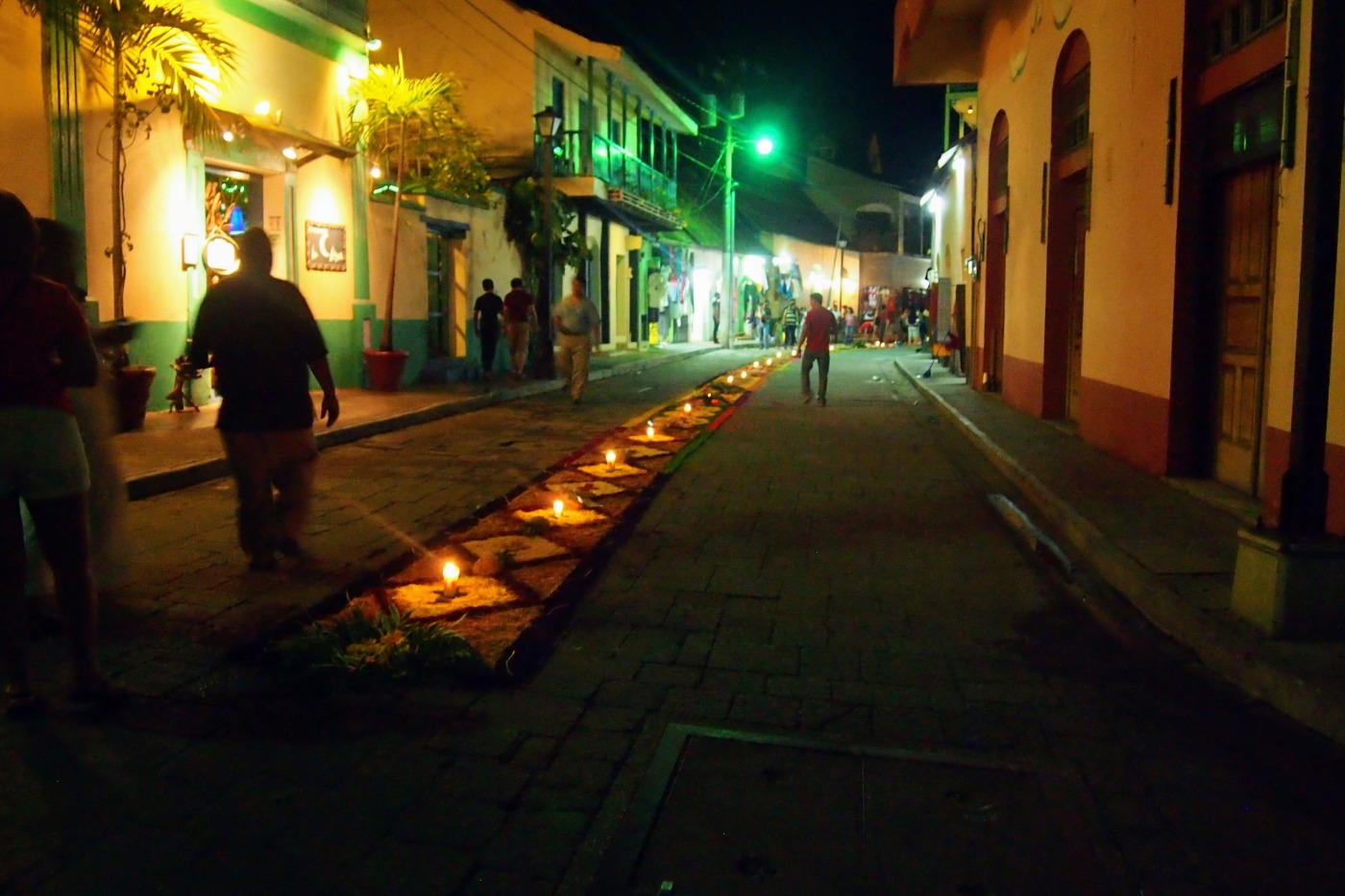 Street scene in Flores Guatemala at night flower carpets and candles