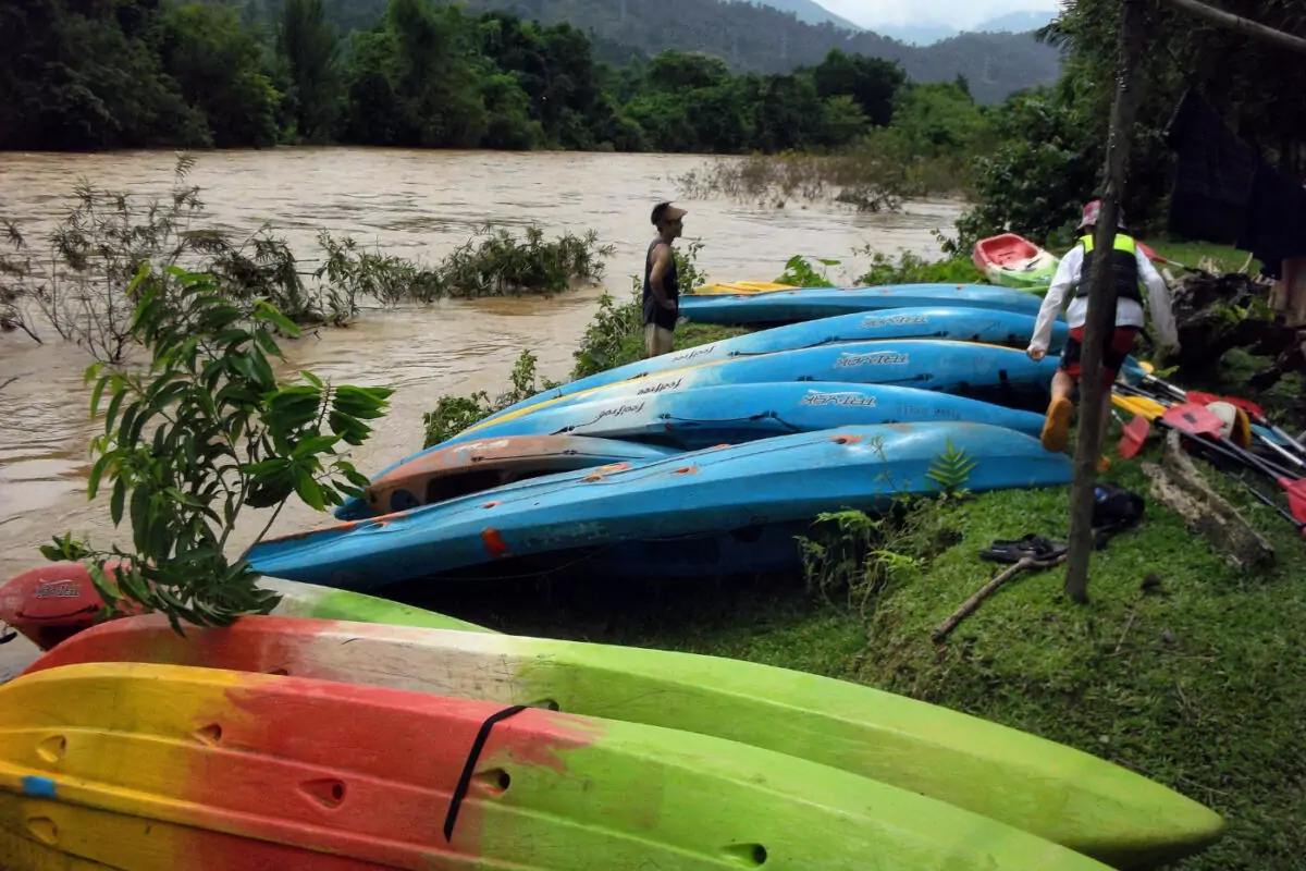 River in flood wet season vang vieng kayaks