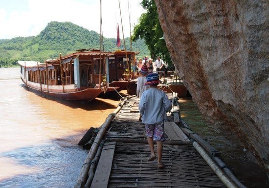 Reaching the entrance to PakOu caves over reed pontoons.