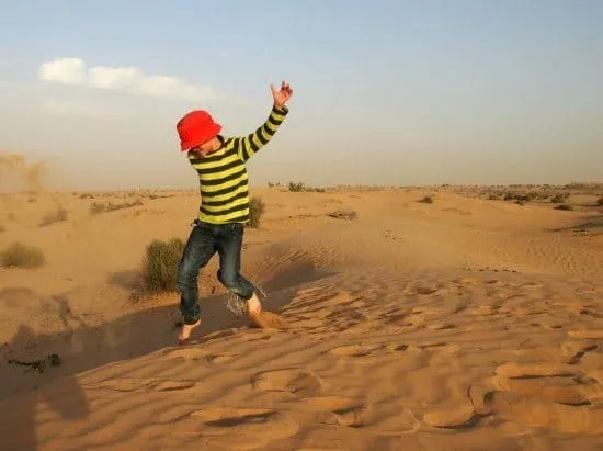 Enjoying the desert sand dunes on our Dubai camel safari .