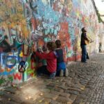 Driving accross Europe, drawing on the Lennon wall in Prague
