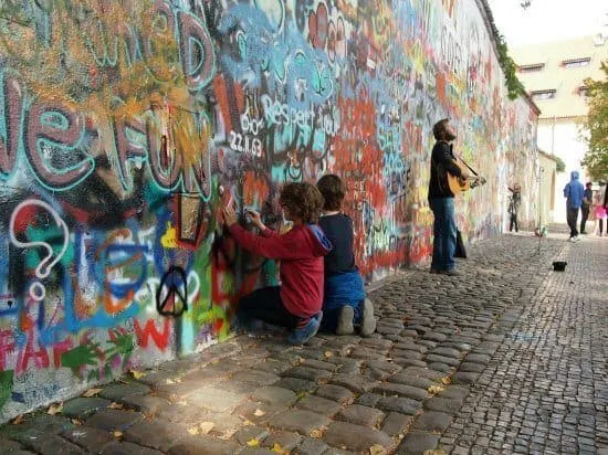 Tour of Prague with kids. The John Lennon Wall is a must see.