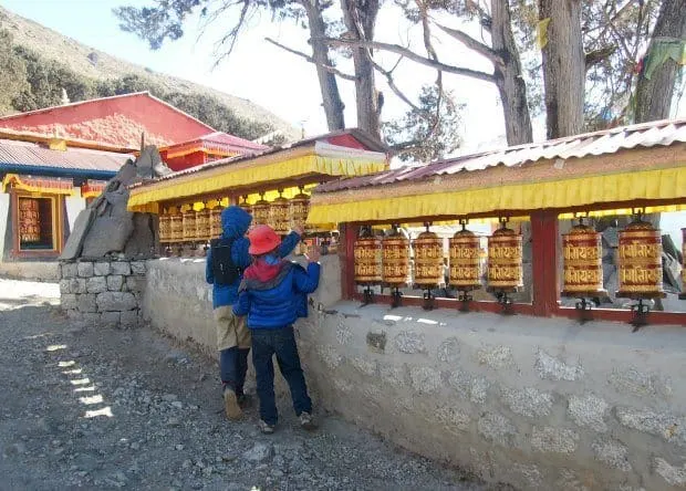 Khumjung Monastery trek, kids spinning prayer wheels