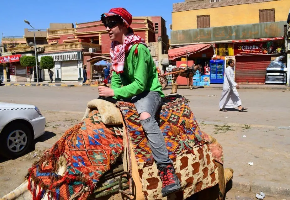 Riding camels at the pyramids Cairo Egypt