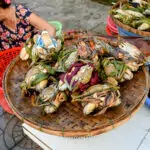 woman at hoi an market selling crabs