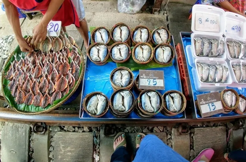 Maeklong Railway market stalls on the train tracks