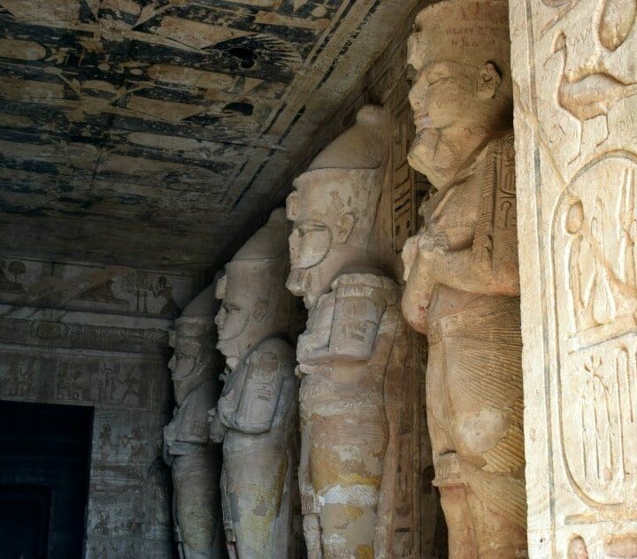 Abu Simbel statues of Rameses. Photograph of inside temple. Rameses statue is lit at dawn. 