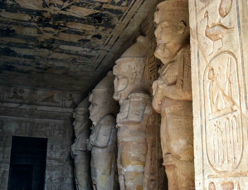 Abu Simbel statues of Rameses. Photograph of inside temple. Rameses statue is lit at dawn. 