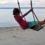 Thailand Western Kid on a beach on a swing