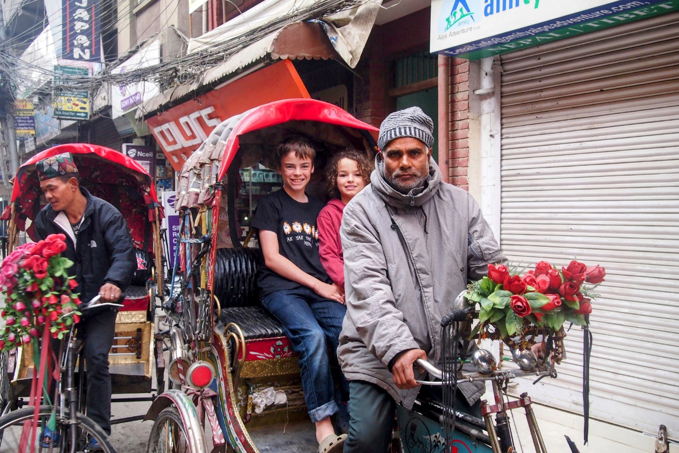 2 children riding a cycle rickshaw in Kathmandu Nepal