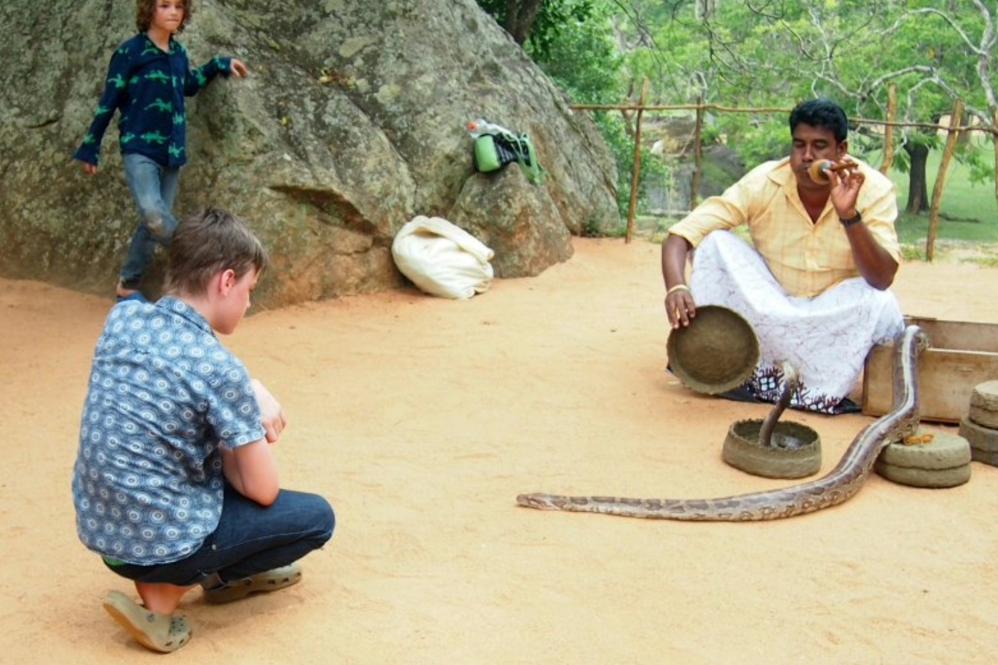 Children watching a snake charmer in sri lanka