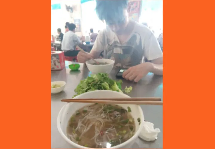 Eating Bun Bo Hue at a noodle shop in Hue City