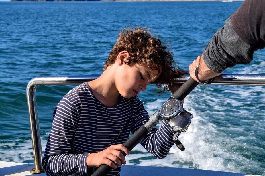 Fishing in Wales with kids boy with fishing gear