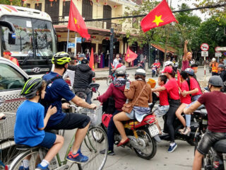 vietnam with kids. Street in Vietnam, tourist kid riding a bicycle.