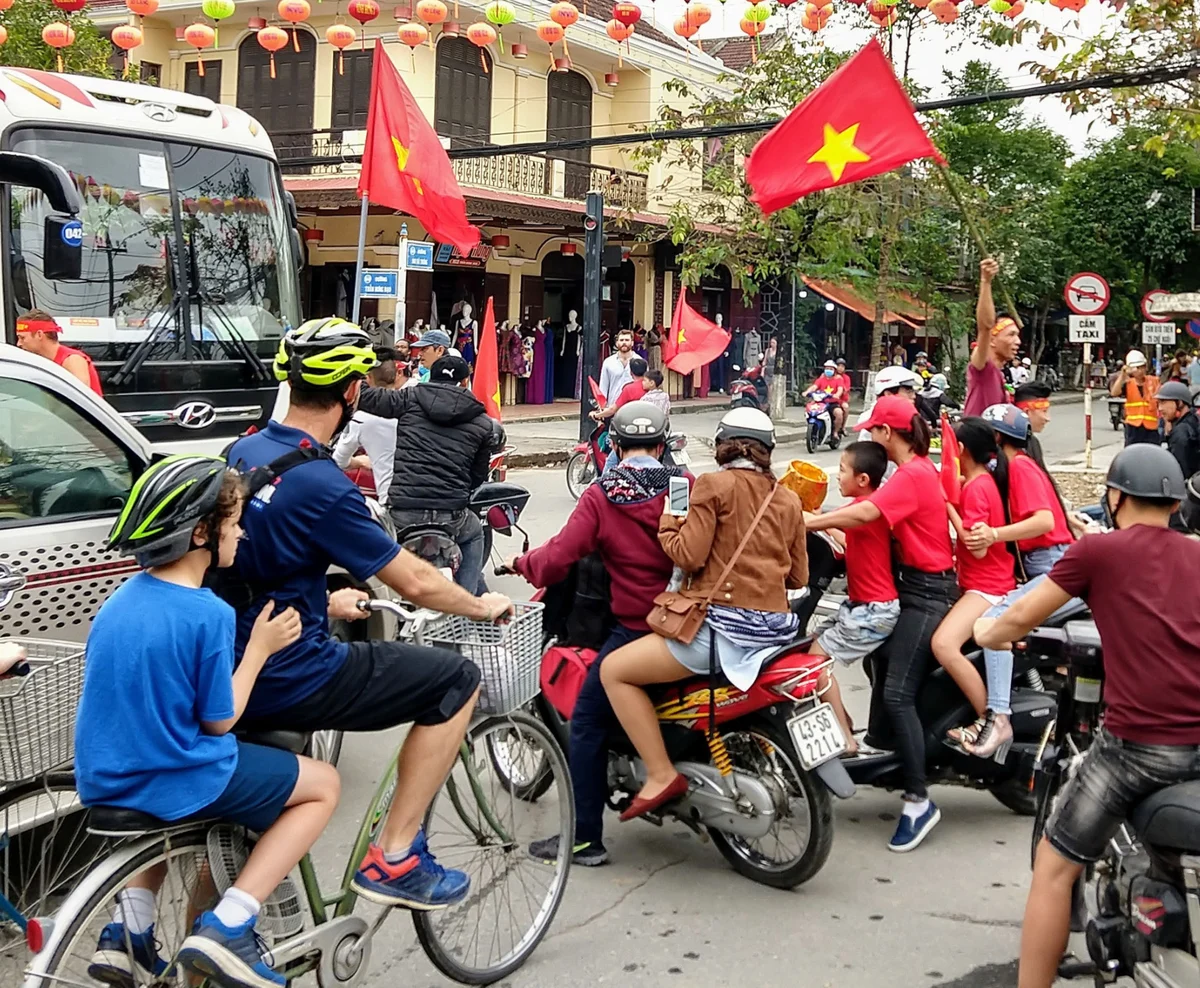 vietnam with kids. Street in Vietnam, tourist kid riding a bicycle.