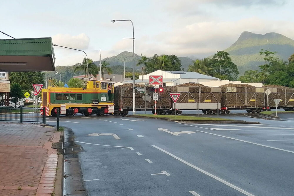 Mossman main street and cane train going to Mossman sugar mill