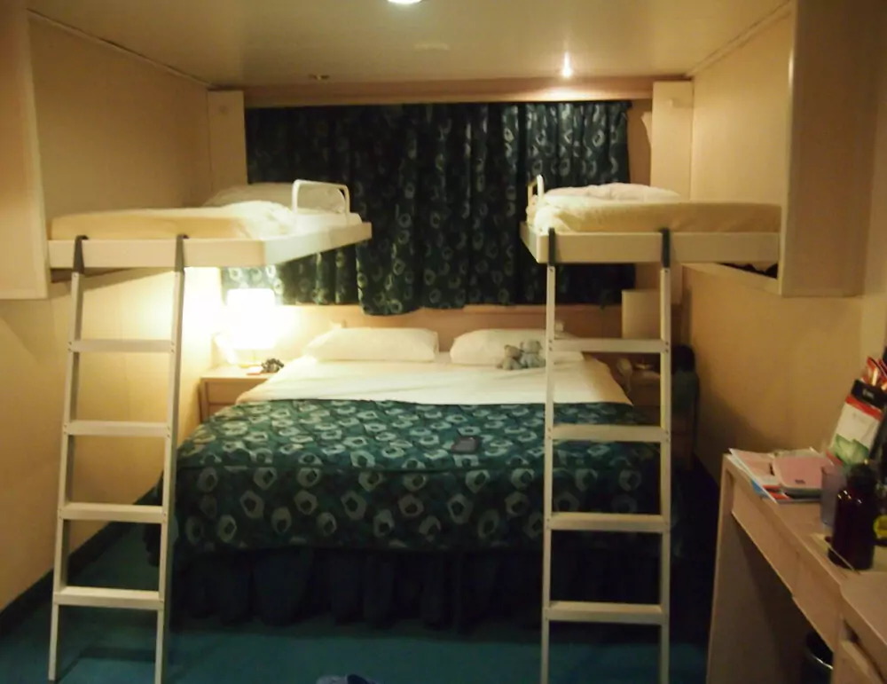 outside window cabin made up with bunks for family cruise ship