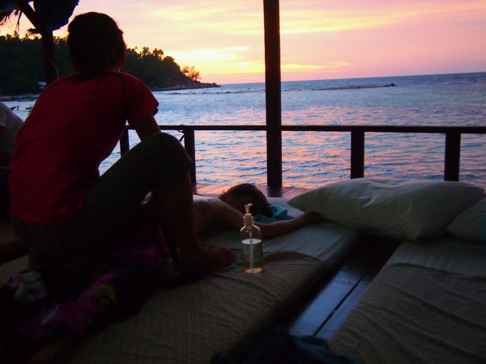 beach massage at sunset Thailand