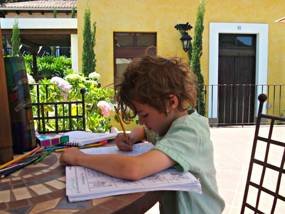 Homeschooling child on the road using a workbook