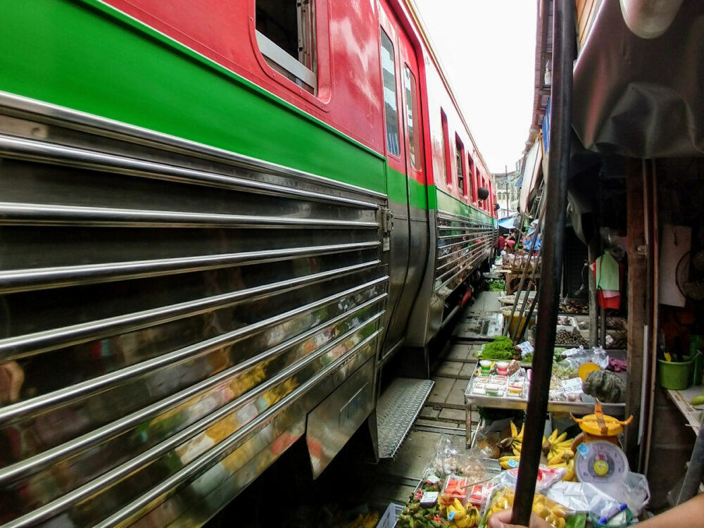 Train in Thailand through market tourist attraction
