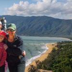 Travelling family standing in front of a beautiful beach