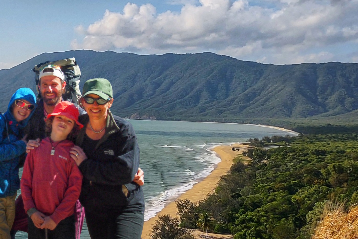 Travelling family standing in front of a beautiful beach