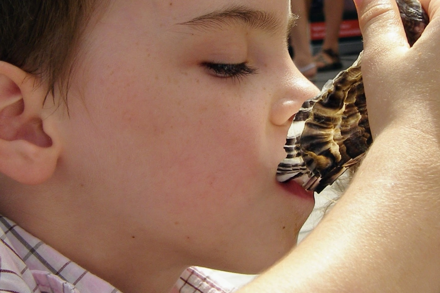 child eating an oyster