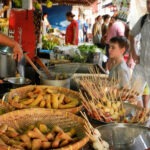 child looking at delicious Thai street food