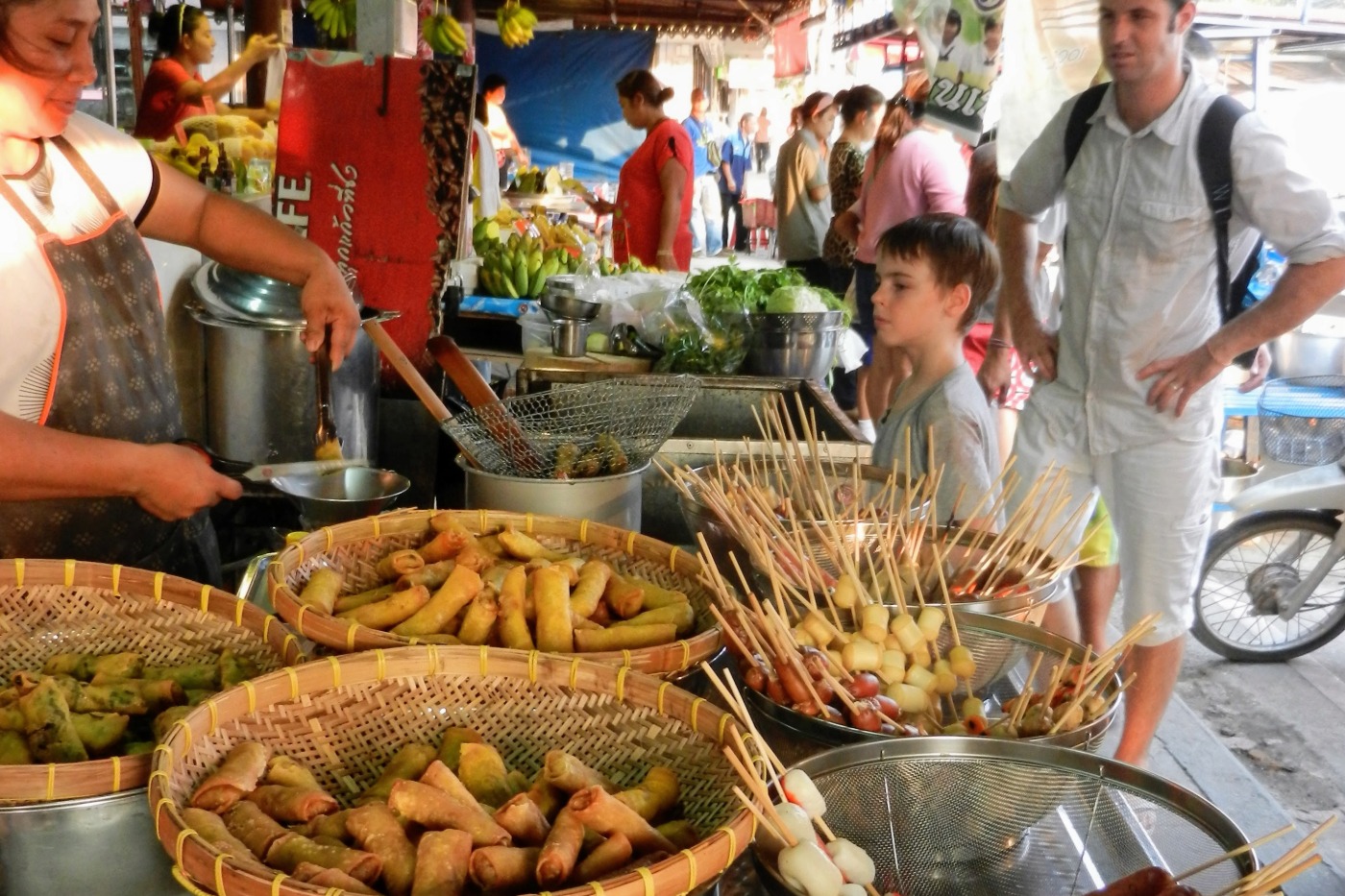 child looking at delicious Thai street food