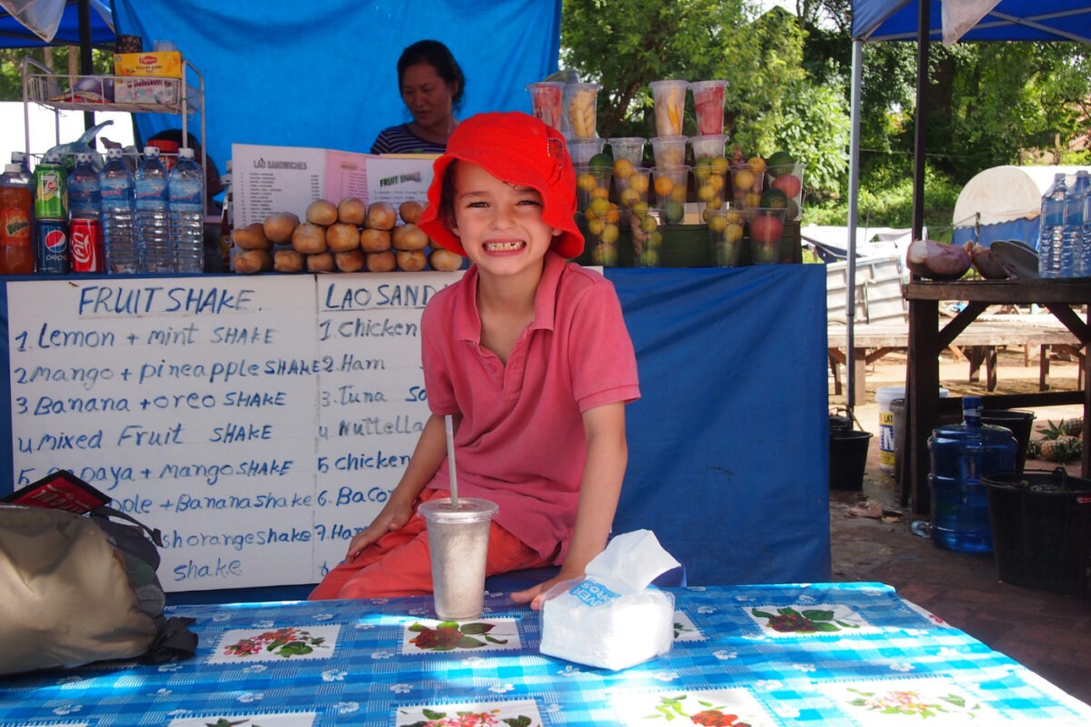 Child drinking a smoothie in Laos