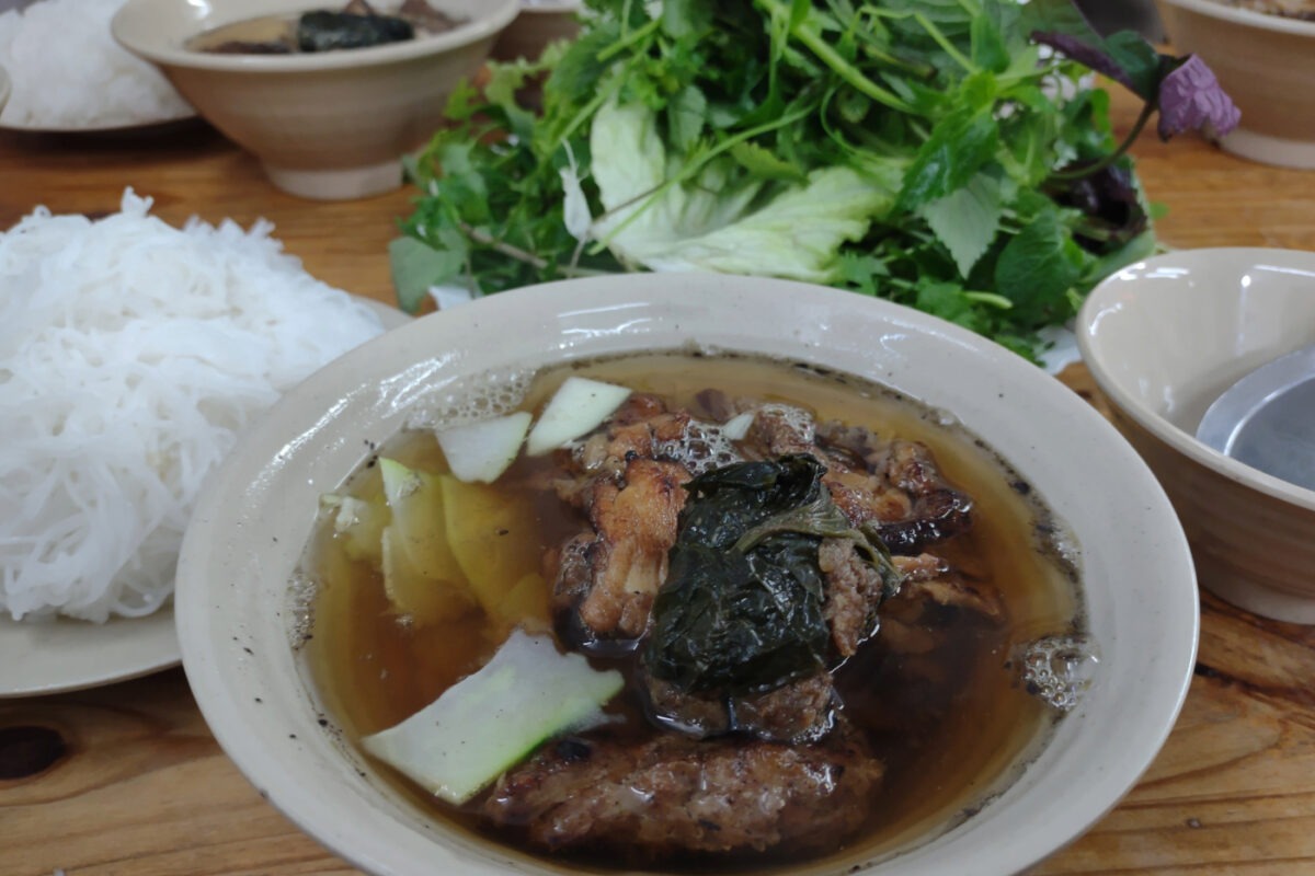 Bowl of bun cha pork soup, fine rive noodles and green salad on the side.