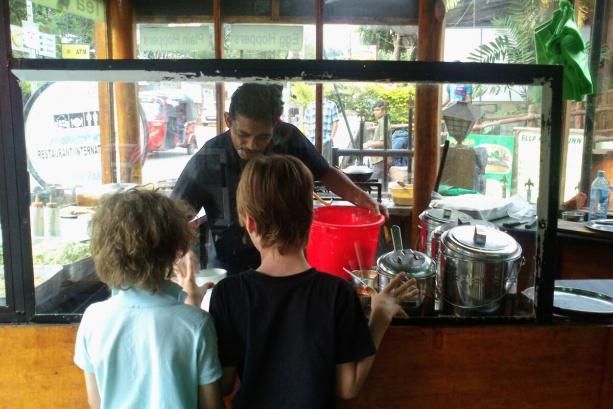 Kids waiting at a food stall in Ella for hoppers.